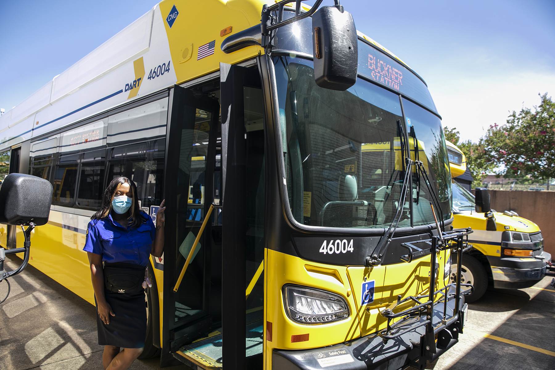 DART bus operator stands next to DART bus.