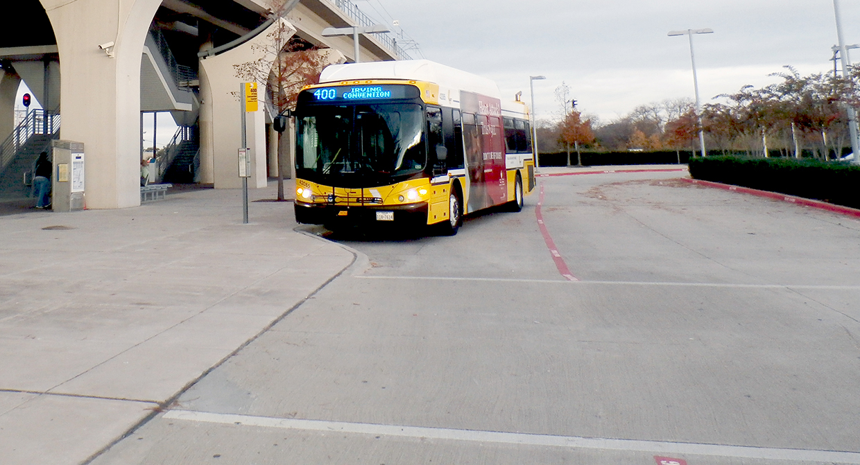 A DART Bus waits for passengers at Downtown Carrollton Station.