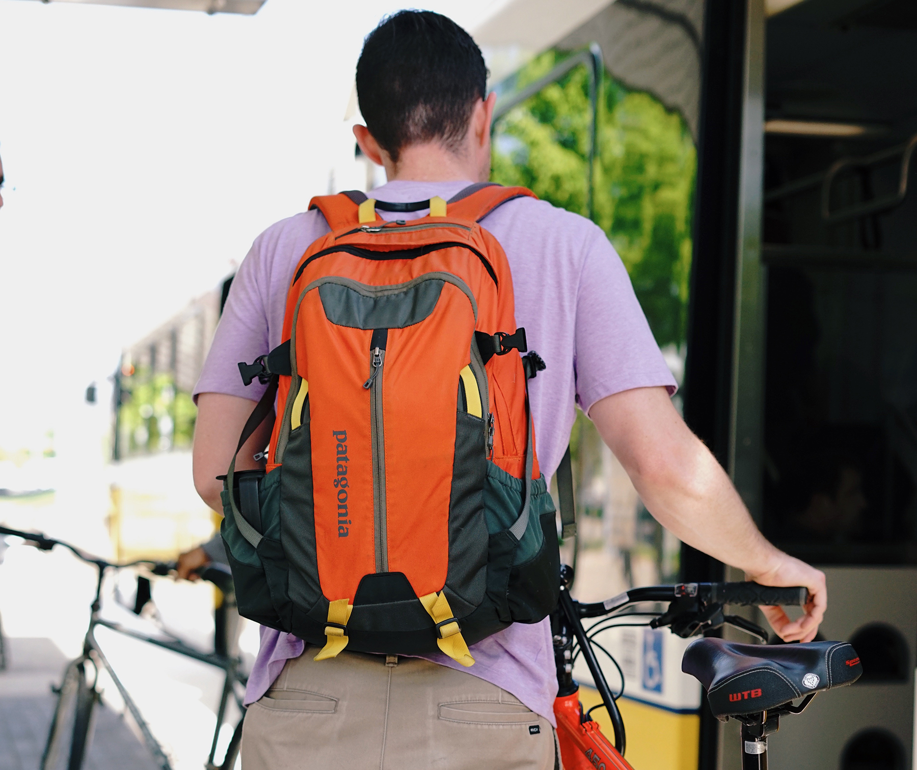 A man pushes his bike to board a DART train. Photo by C. Cross.