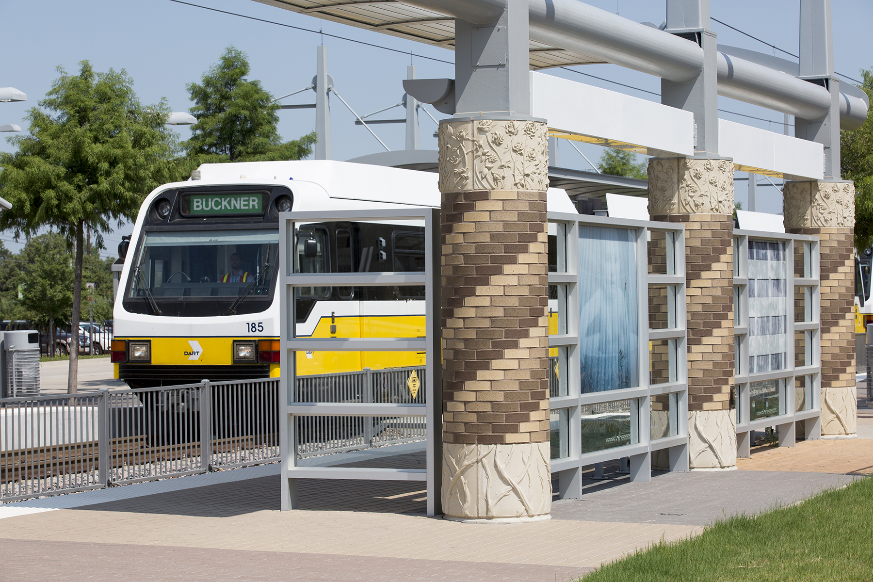 A DART Green Line train stops at Farmers Branch Station.